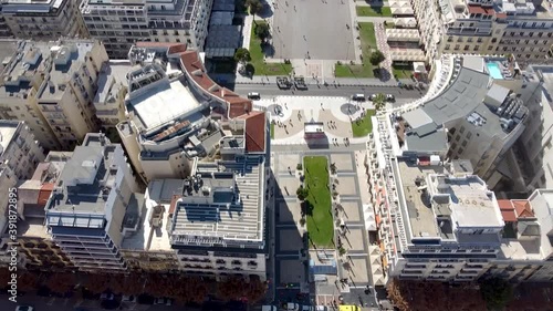 Aerial shot of Aristotelous square in the center of Thessaloniki, Greece, street with cars, forward movement by drone photo