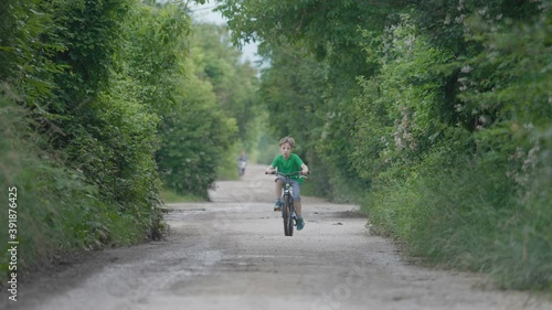 Wallpaper Mural Portrait of child riding a bike on empty rural road, free holiday Torontodigital.ca