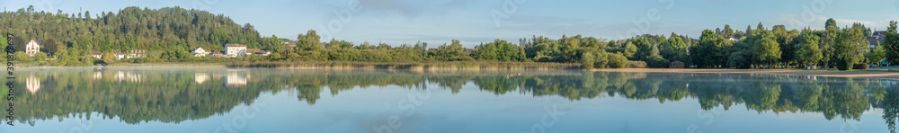Clairvaux-Les-Lacs, France - 09 03 2020: Reflections on the big lake - La Raillette
