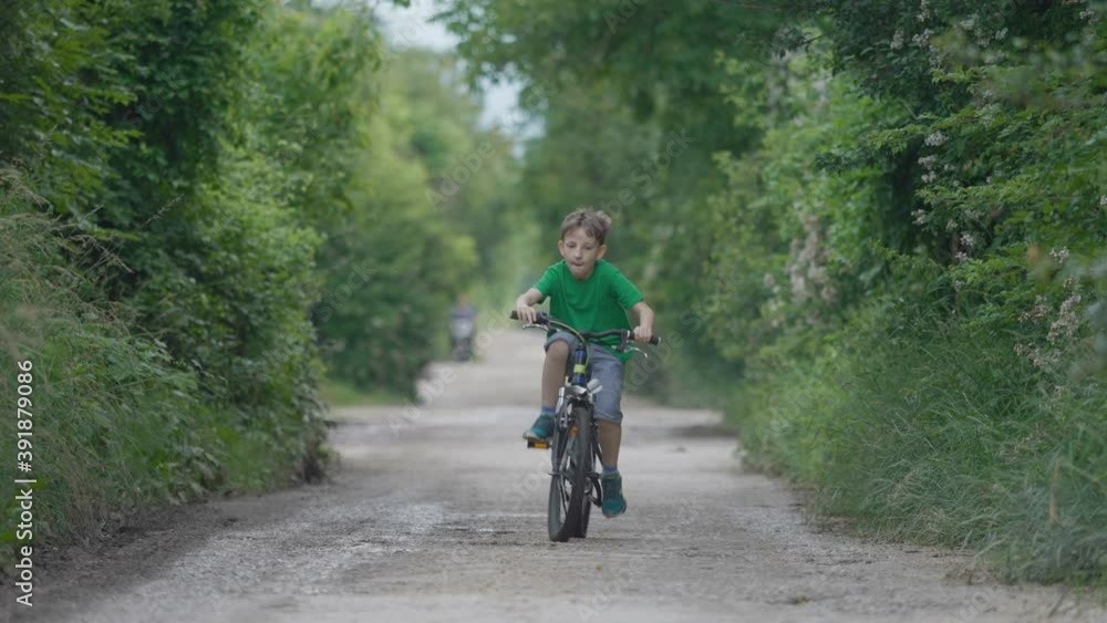 One child riding a bike on rural road, freedom play, active outdoor One child riding a bike on rural road, freedom play, active outdoor