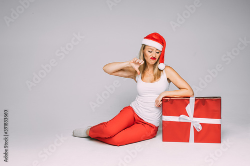 cheerful caucasian woman with red and white hat doesnt like her gift photo