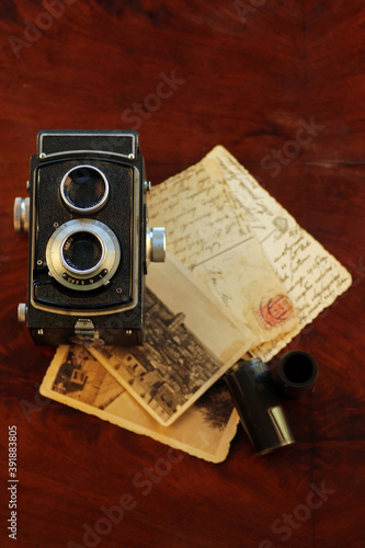 Old, vintage TLR camera - twin lens reflex and old postcards 