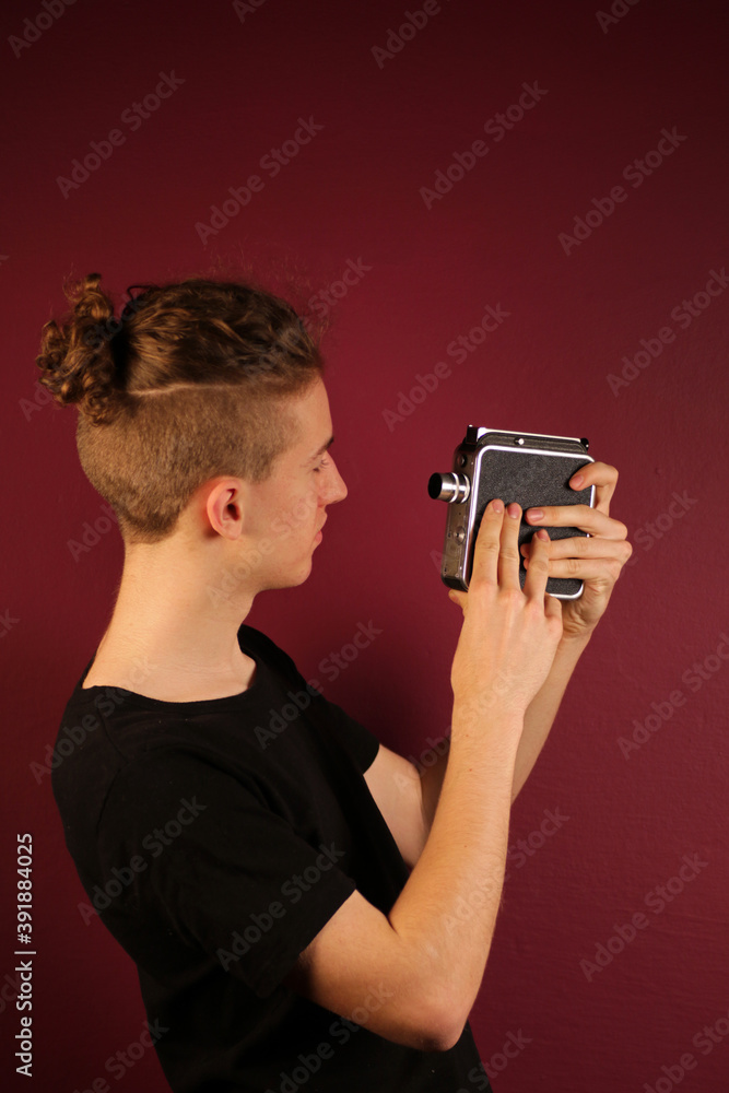 Young cinematographer with old, retro camera