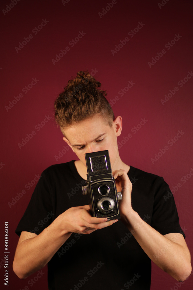 Fototapeta premium Young photographer with old, retro camera