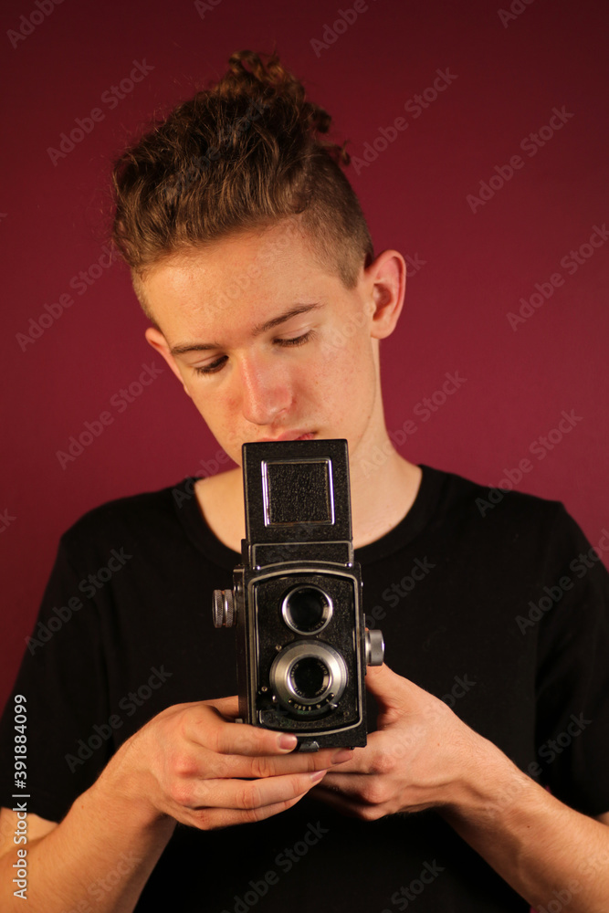 Fototapeta premium Young photographer with old, retro camera