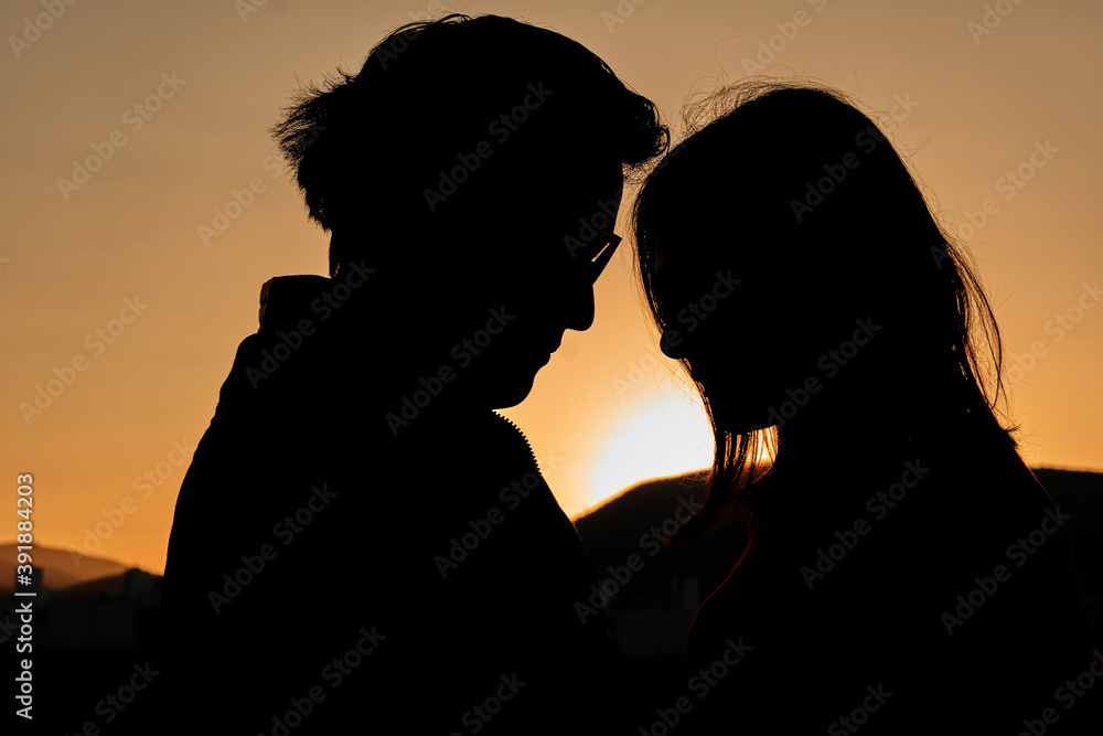 Couple backlit at sunrise