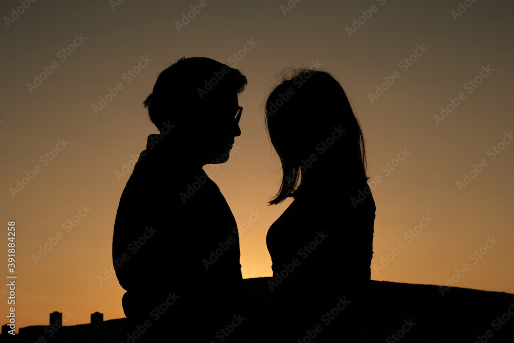 Couple backlit at sunrise