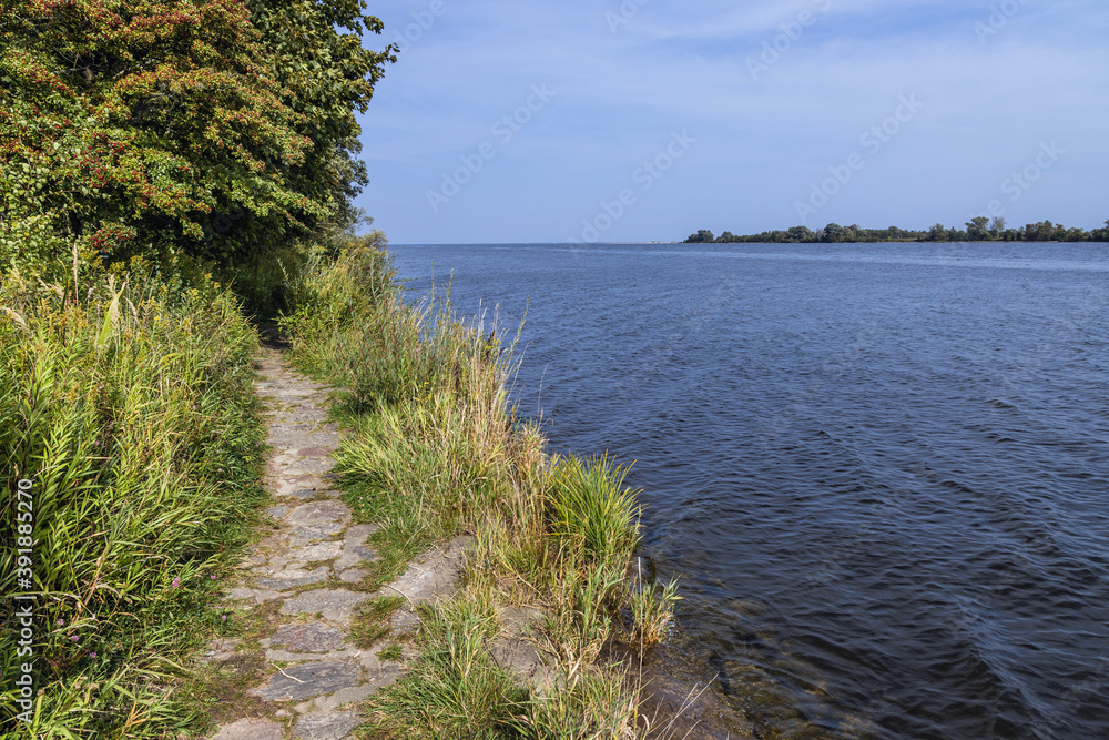 Path on Sobieszewo Island along Wisla Smiala - one of the mouths of the Vistula River in Gdansk, Poland Path on Sobieszewo Island along Wisla Smiala - one of the mouths of the Vistula River in Gdansk, Poland