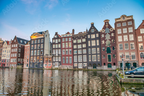 Classic buildings of Amsterdam along city canals on a sunny afternoon, The Netherlands