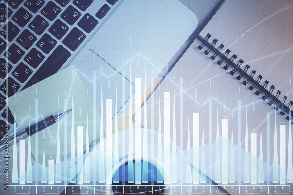 Stock market graph and top view computer on the table background. Double exposure. Concept of financial education. Stock market graph and top view computer on the table background. Double exposure. Concept of financial education.