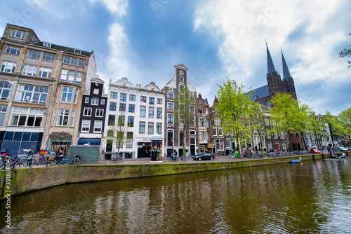 AMSTERDAM, THE NETHERLANDS - APRIL 25, 2015: Traditional houses and buildings on the canal