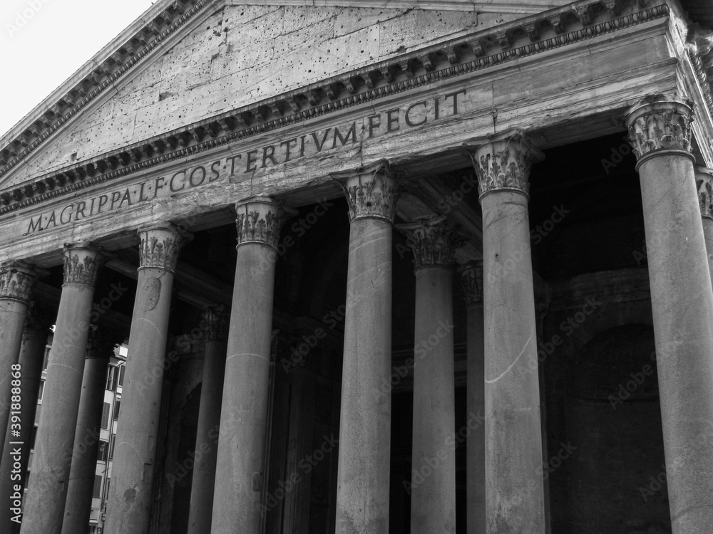 Rome, Italy - A black and white image of the exterior of The Pantheon, including  the grand Corinthian columns and Latin words engraved on top.  Image has copy space.