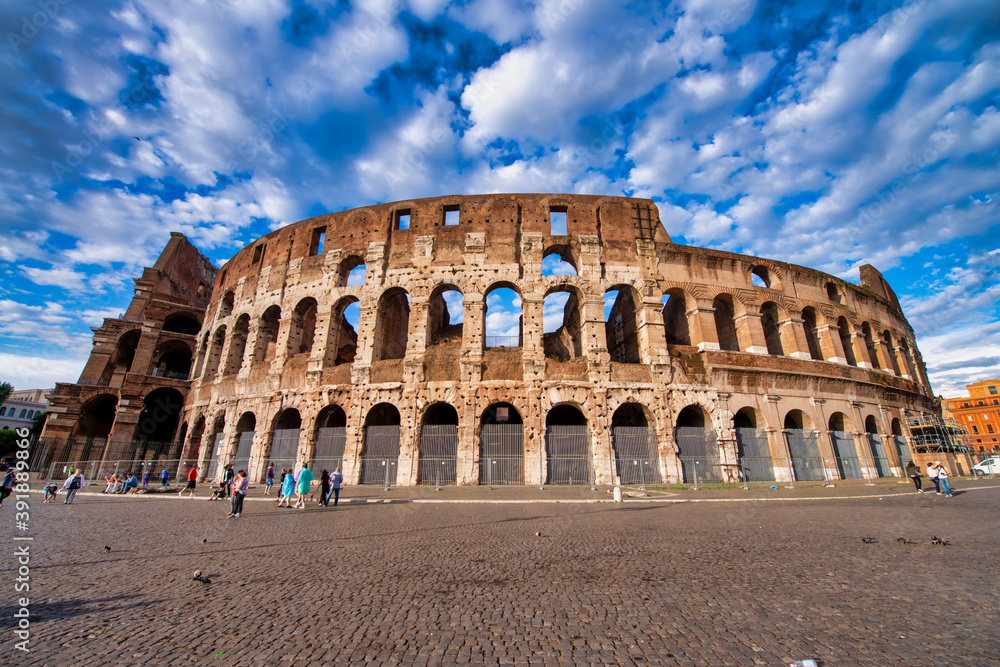 ROME, ITALY - JUNE 2014: The Colosseum and the homonymous square on a summer day
