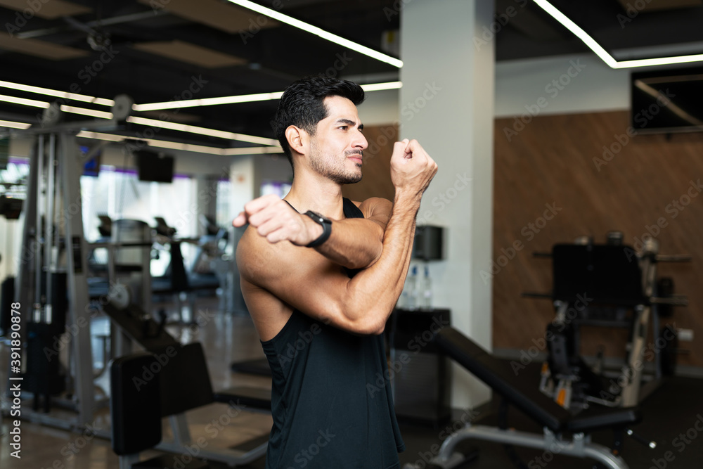Hispanic man warming up before a workout Hispanic man warming up before a workout