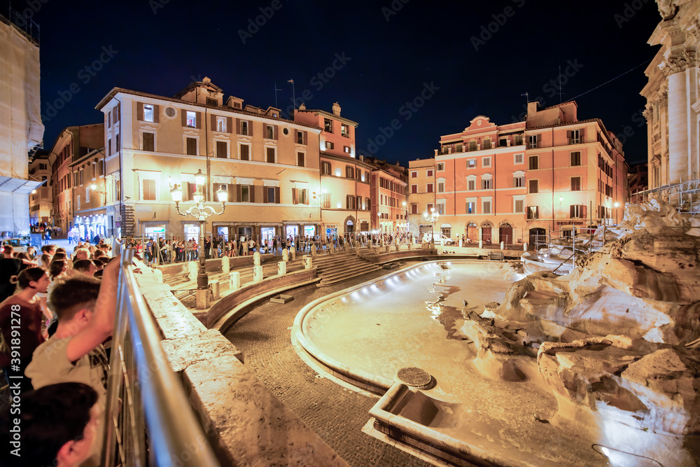 ROME, ITALY - JUNE 2014: Tourists enjoy the beautiful Trevi Fountain on a summer night