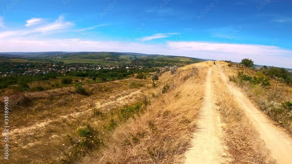 Green hills, fields and a village in Moldova. Wide angle. Slow motion Green hills, fields and a village in Moldova. Wide angle. Slow motion