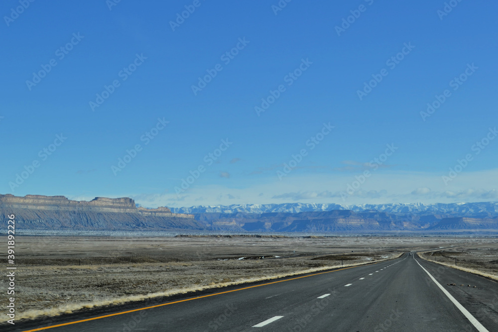 Road with view of mountains covered by snow, Moab, Utah