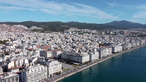 Aerial shot of Aristotelous square in the center of Thessaloniki, Greece, street with cars and urban coastline, forward movement  by drone photo