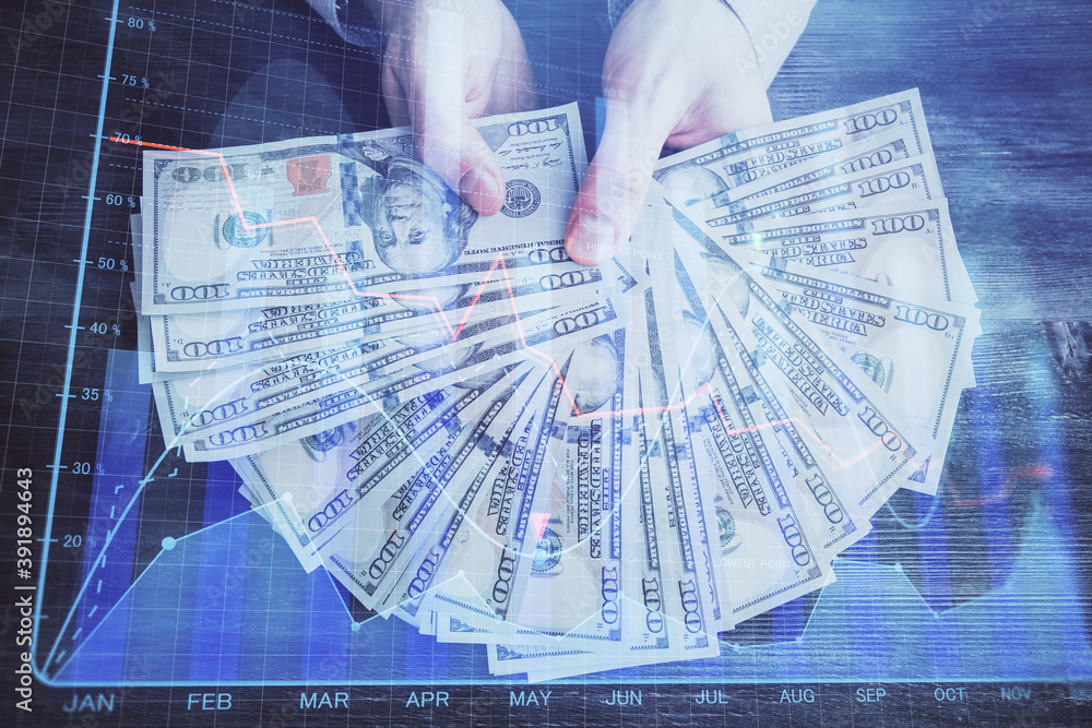 Multi exposure of financial graph drawing hologram and USA dollars bills and man hands. Analysis concept. Multi exposure of financial graph drawing hologram and USA dollars bills and man hands. Analysis concept.