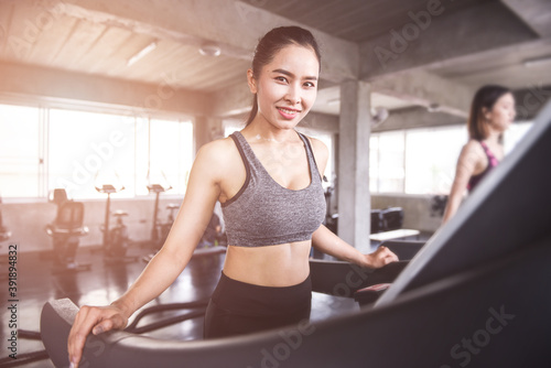 Attractive Asian woman exercising in the gym