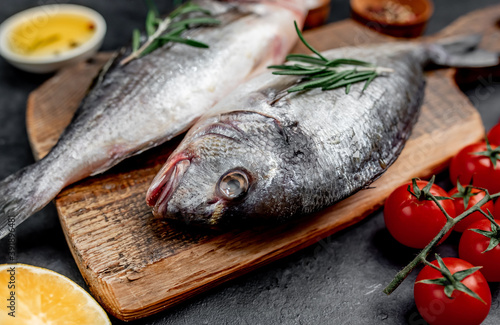  Raw dorado fish with spices on a stone background