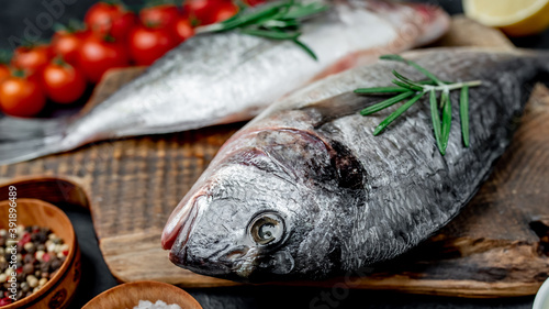  Raw dorado fish with spices on a stone background