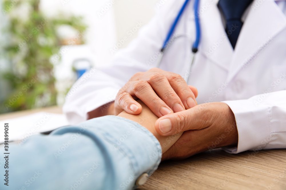 A Chinese doctor in a white lab coat is checking the pulse of a patient A Chinese doctor in a white lab coat is checking the pulse of a patient