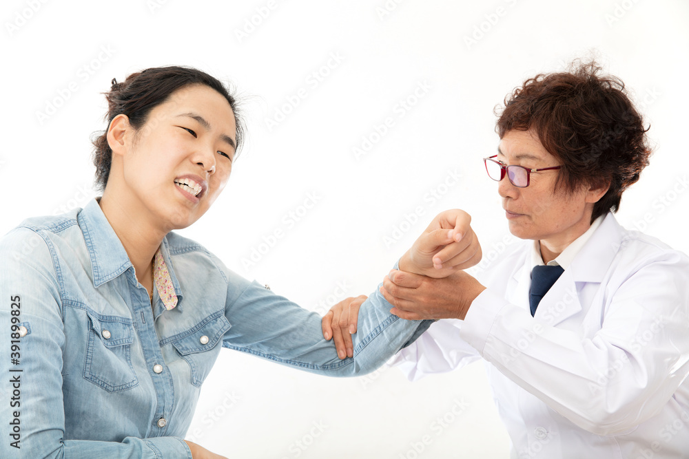 The orthopedist is examining the injury of the patient’s arm The orthopedist is examining the injury of the patient’s arm