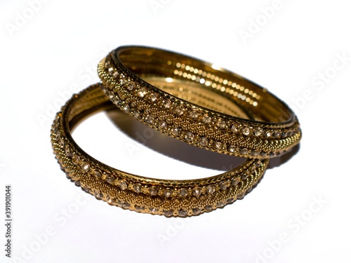 Indian traditional gold coated wedding Bangles isolated on white. photo