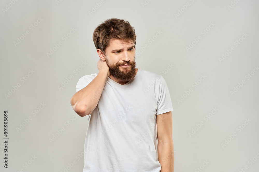 man in white t-shirt gesturing with his hands studio dissatisfaction lifestyle light background man in white t-shirt gesturing with his hands studio dissatisfaction lifestyle light background
