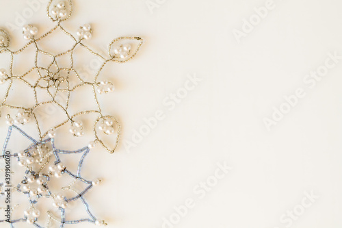 Snowflakes made of beads on a white background. Christmas background. Christmas mood.