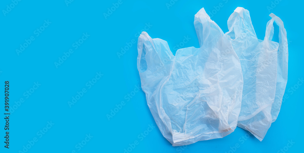 White plastic bags on blue background. Copy space White plastic bags on blue background. Copy space