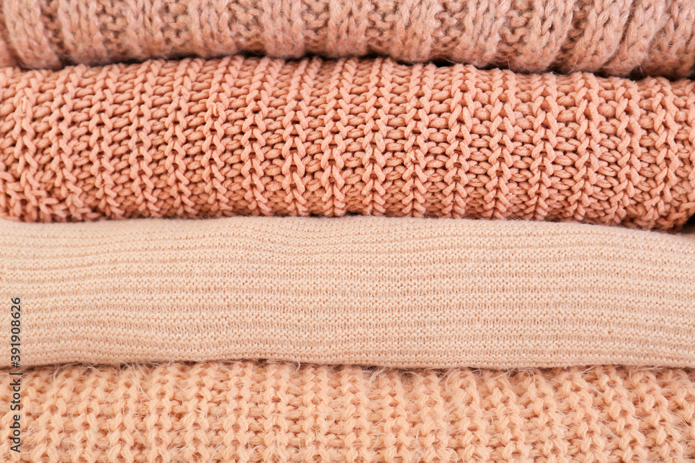 Stack of warm winter clothes as background Stack of warm winter clothes as background