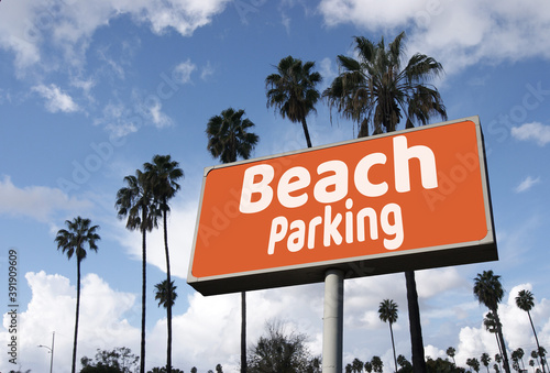 Aged and worn beach parking sign with palm trees