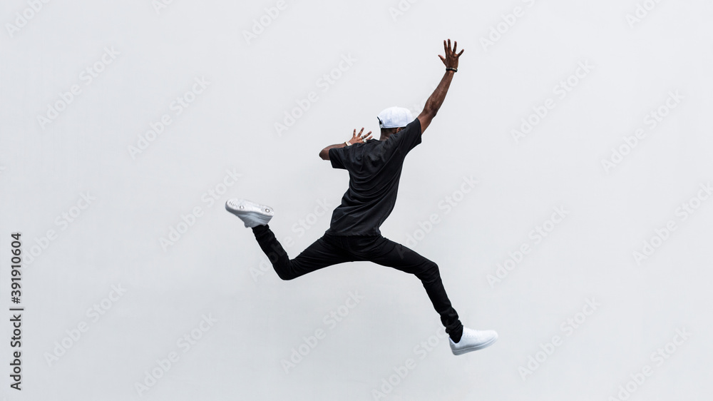 Fototapeta Black man jumping in to the air