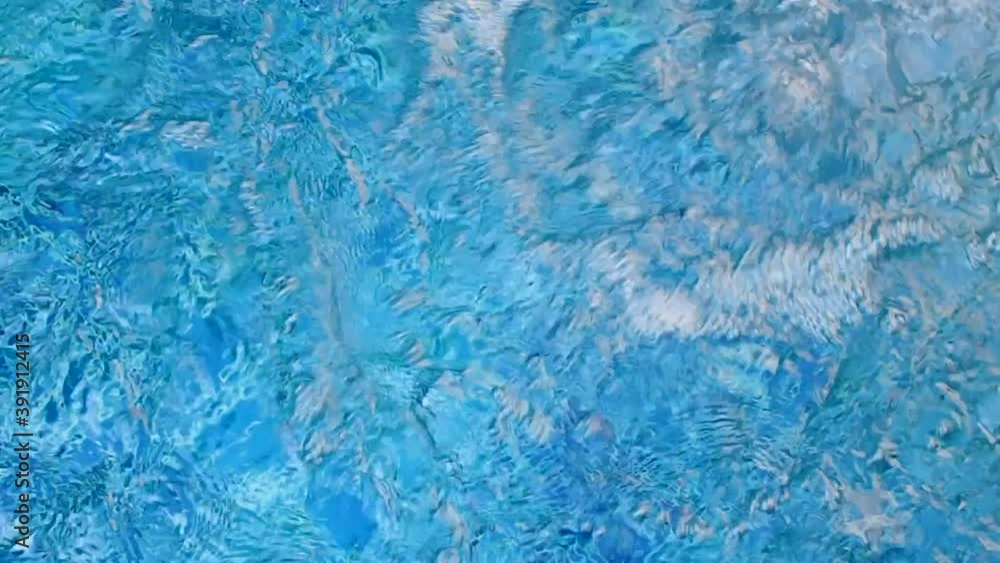 flowing water in a swimming pool with the underwater jet system making a ripple on the surface. top view flowing water in a swimming pool with the underwater jet system making a ripple on the surface. top view