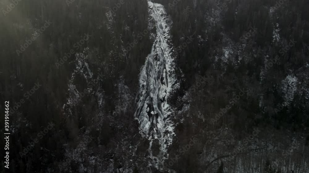 White Cascade Flowing Down From Forest Hills During Winter In Vallee Bras-du-Nord At Saint-Raymond, Canada. - Aerial Pullback Shot White Cascade Flowing Down From Forest Hills During Winter In Vallee Bras-du-Nord At Saint-Raymond, Canada. - Aerial Pullback Shot
