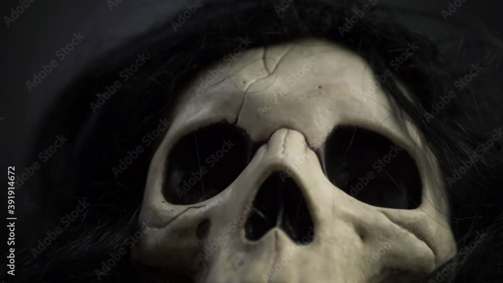 Creepy skull with black hair close up tilting shot Creepy skull with black hair close up tilting shot