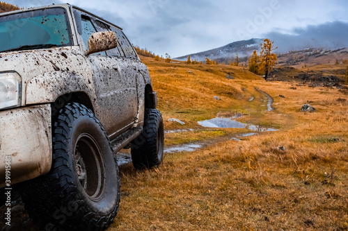 Dirty offroad suv in autumn. Offroad journey trip concept. Overlanding, travel in autumn concept. 23.09.2020 Katon, Kazakhstan.