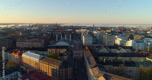 Aerial view over quiet streets, in Helsinki, during sunrise, in Helsingfors, Finland - Reverse, drone shot photo