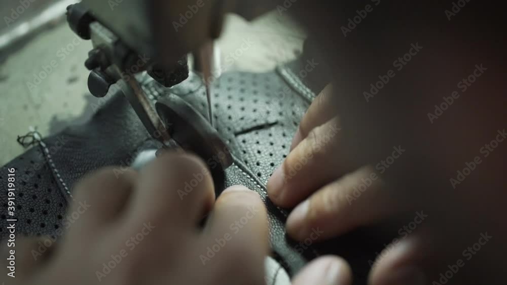 Closeup Of Sweatshop Worker Sewing Leather Gloves For Fashion Industry Closeup Of Sweatshop Worker Sewing Leather Gloves For Fashion Industry