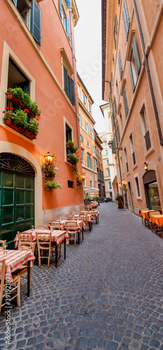 Beautiful classic street of Rome with Open Air Restaurants in summer season  Italy