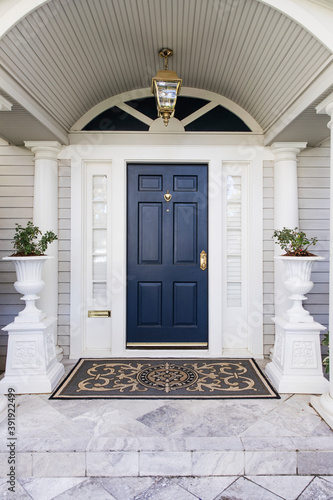 entrance to the house with a dark blue front door