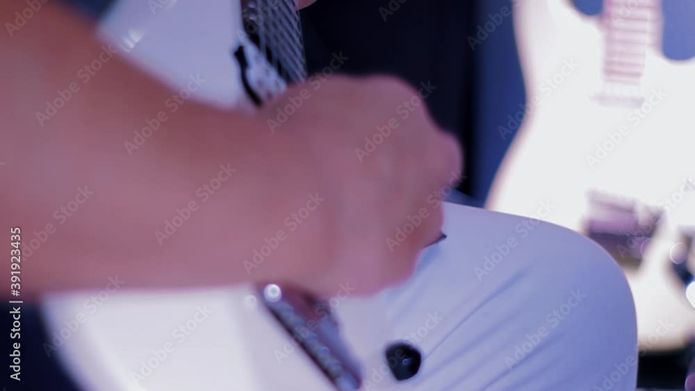 a guitarist plays the white guitar a guitarist plays the white guitar