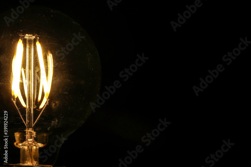 Light bulb tungsten LED on off flicker on black background © oqba