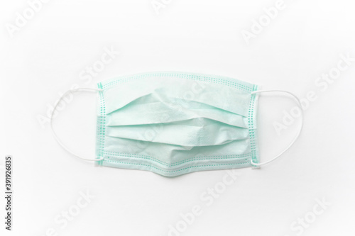 Surgical mask with rubber ear straps isolated on white background. White mask to cover the mouth and nose.
