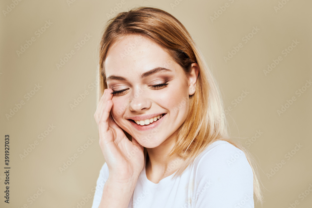 Cheerful blonde gesturing with her hands studio beige background Cheerful blonde gesturing with her hands studio beige background