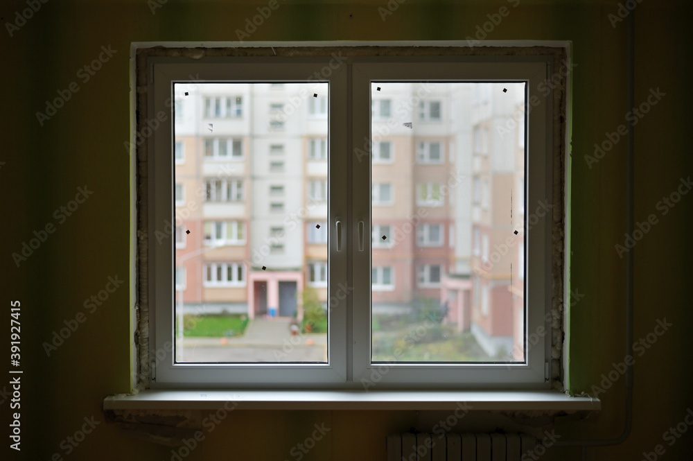 Photo of a finished new double-leaf window in a city apartment