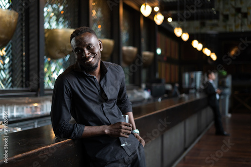 Photography Portrait of confident African American businessman at nightclub.
