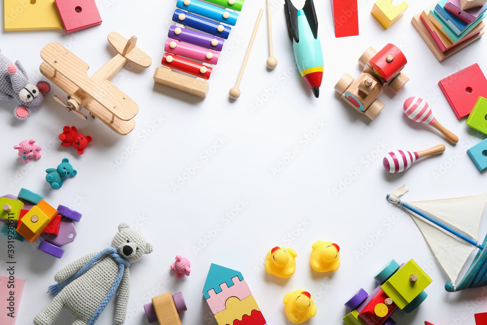 Frame of different toys on white background, flat lay. Space for text